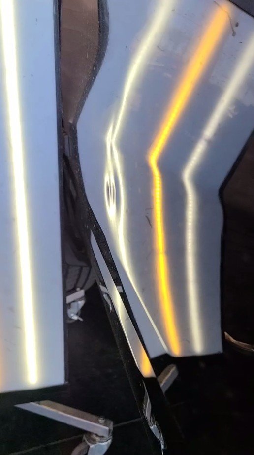Body-line dent shown under a PDR reflection board